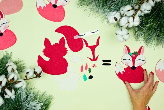 all of the elements that make up the free Christmas tree ornament pattern. This adorable Felt Fox Ornament DIY (Free Pattern) is a fun addition to your Christmas tree Ornaments!  Curled up in it's tail with a bit of holly on it's head this fox is the embodiment of merriment.  Use for tree decorations or as a fun addition to a wrapped gift.  Also makes a wonderful hostess gift or prize at a holiday party. Perfect handmade ornament to make.