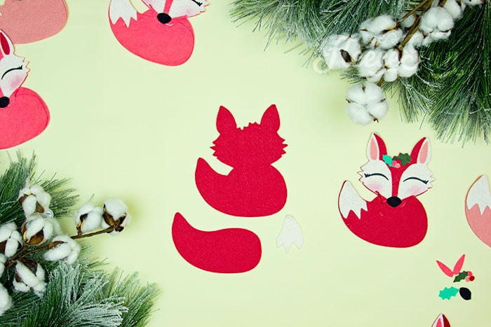 beginning to put the ornament together. This adorable Felt Fox Ornament DIY (Free Pattern) is a fun addition to your Christmas tree Ornaments!  Curled up in it's tail with a bit of holly on it's head this fox is the embodiment of merriment.  Use for tree decorations or as a fun addition to a wrapped gift.  Also makes a wonderful hostess gift or prize at a holiday party. Perfect handmade ornament to make.