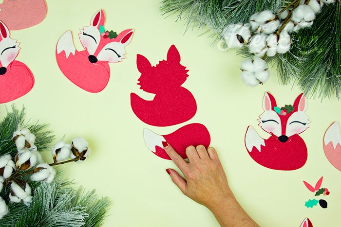 addin the fur to the end of the tail. This adorable Felt Fox Ornament DIY (Free Pattern) is a fun addition to your Christmas tree Ornaments!  Curled up in it's tail with a bit of holly on it's head this fox is the embodiment of merriment.  Use for tree decorations or as a fun addition to a wrapped gift.  Also makes a wonderful hostess gift or prize at a holiday party. Perfect handmade ornament to make.