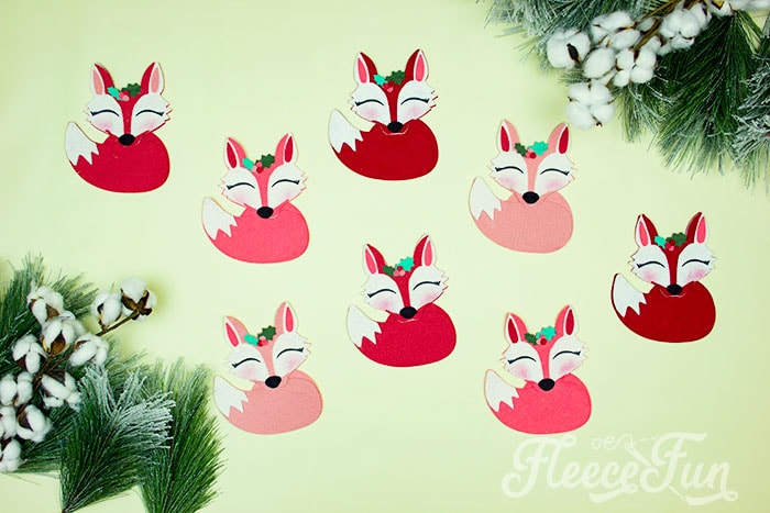 This adorable Felt Fox Ornament DIY (Free Pattern) is a fun addition to your Christmas tree Ornaments!  Curled up in it's tail with a bit of holly on it's head this fox is the embodiment of merriment.  Use for tree decorations or as a fun addition to a wrapped gift.  Also makes a wonderful hostess gift or prize at a holiday party. Perfect handmade ornament to make.