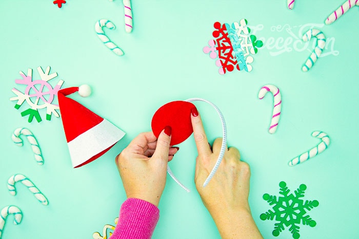 Attaching the mini Santa hat to the headband with fleecefun’s free template