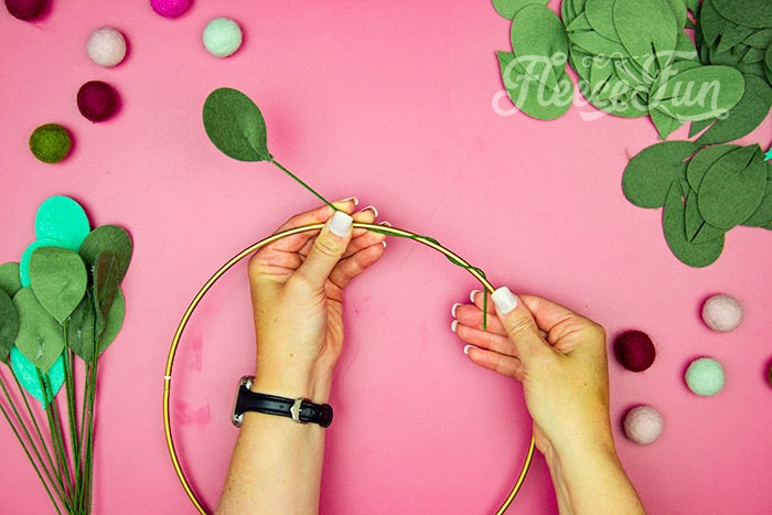twisting wire onto hoop. This modern Christmas Wreath DIY (made from felt) is a whimsical addition to your holiday décor. With a few items you can make this festive wreath. Because of the way it's constructed no two are alike. Make it as full or as thin as your taste's desire. Because it's made from felt, this wreath can be made in an array of colors to suit your style.