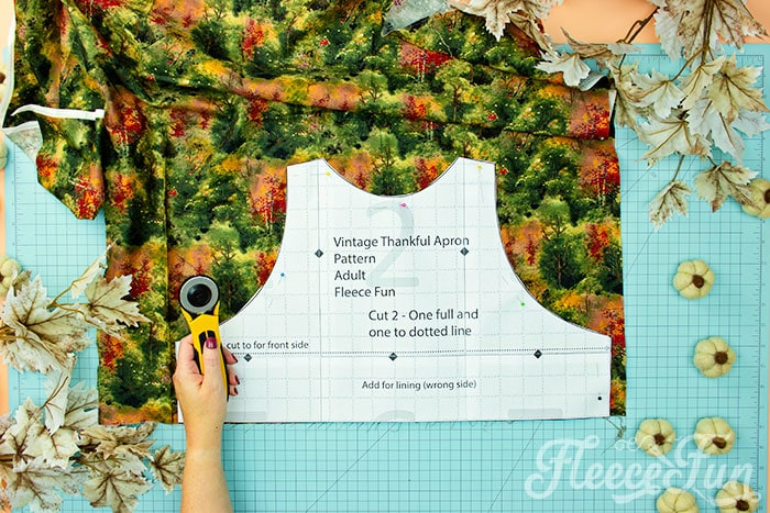 Bodice of apron being cut out. This Free apron pattern and tutorial includes a pdf pattern and video! Make a vintage style apron that is chic.