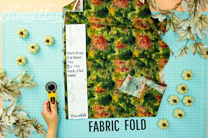 Neck strap placed on fold for cutting out. This Free apron pattern and tutorial includes a pdf pattern and video! Make a vintage style apron that is chic.