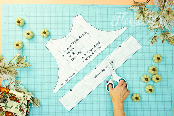 picture of how to cut the free apron pattern down to cut out front of bodice. This Free apron pattern and tutorial includes a pdf pattern and video! Make a vintage style apron that is chic.