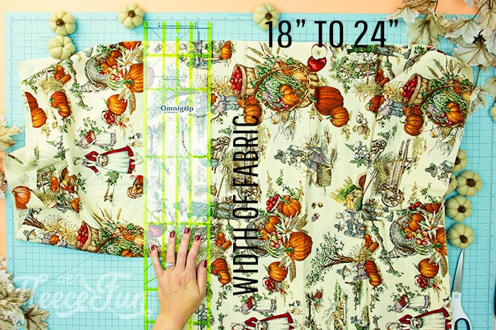 skirt being cut out from fabric for apron. This Free apron pattern and tutorial includes a pdf pattern and video! Make a vintage style apron that is chic.