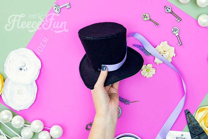 Image of decorating the mini top hat for a wearable look from fleecefun tutorial