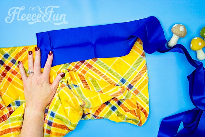 Attaching satin binding to a fleece blanket, guided by fleecefun’s free instructions