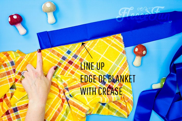 Satin binding being sewn to fleece blanket in fleecefun’s DIY tutorial