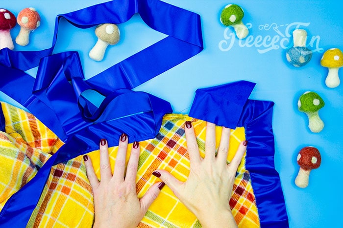 Completing a satin bound fleece blanket, guided by fleecefun’s free tutorial