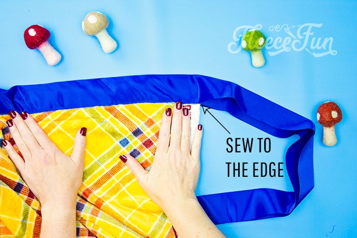 showing where to stitch, along the edge of the blanket
