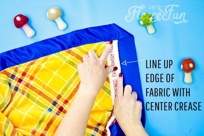 Creating mitered corners on a satin bound fleece blanket, from fleecefun’s tutorial