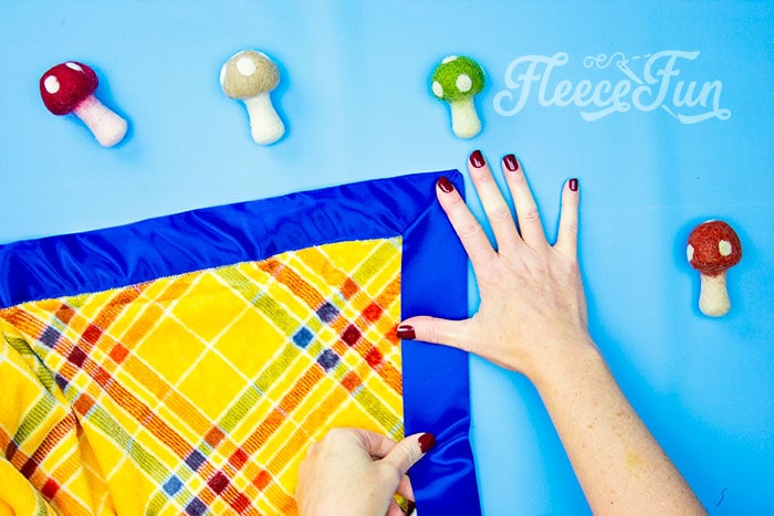 Mitering satin corners on a fleece blanket, as detailed in fleecefun’s free instructions