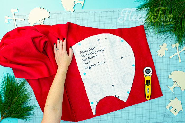 Cutting out the hood to the free cape pattern. Will keep the chill from nipping, but not the wolves. This cape has a video tutorial with a FREE sewing pattern. It's only six steps - looks DIY easy! Love this fleece sewing Project - Red Riding Hood Cape Pattern. It's a great costume pattern that has a classic look. It can work for different costumes. Perfect for Halloween. I love how the sewing tutorial is geared for beginners. It's a great beginner sewing project.
