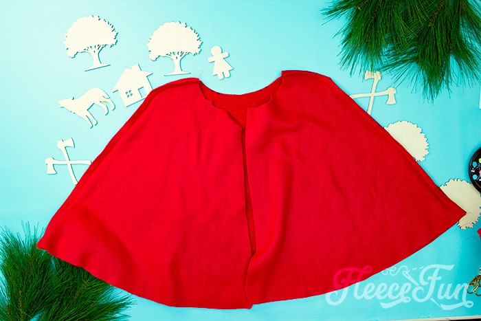 The bottom half of the red riding hood cap sewn together, inside out.