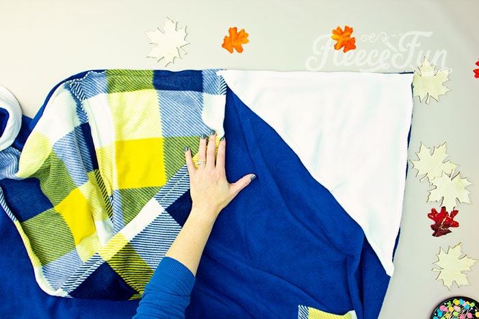 Securing the hood and handwarmers to the fleece blanket with FleeceFun.