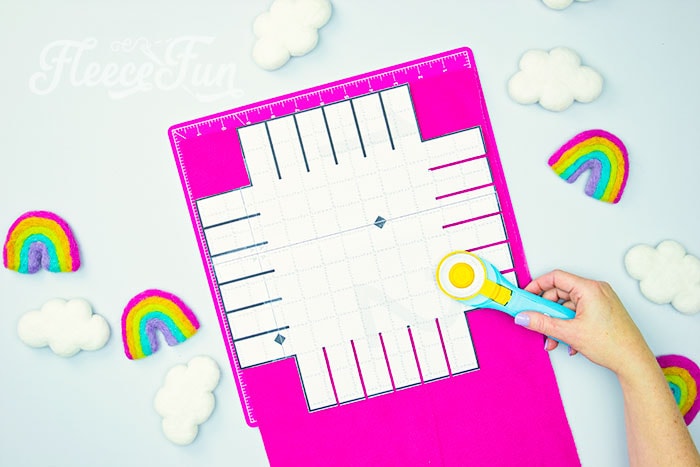 Cutting squares for your patchwork tie blanket using fleecefun free template and tutorial.