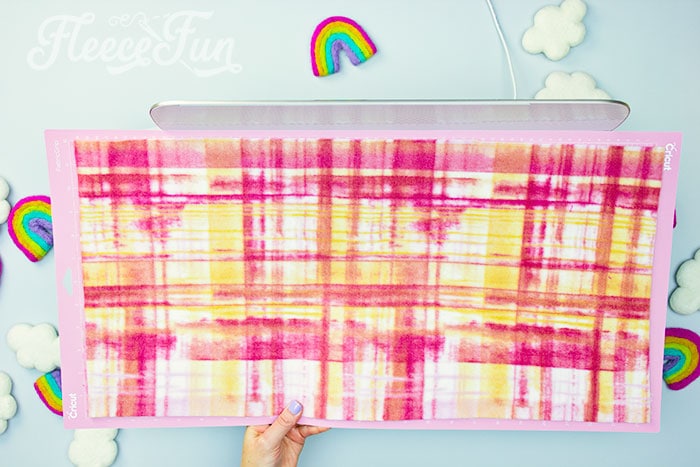 Cut fleece fabric into squares for a patchwork blanket using fleecefun free template.