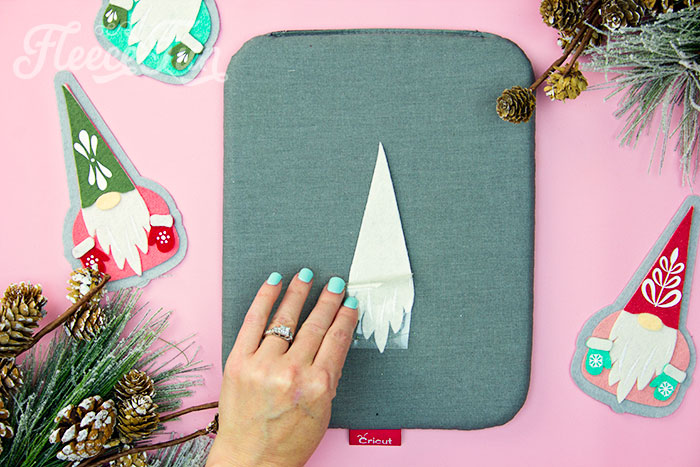 Adding HTV to your felt gnome ornament using fleecefun’s step-by-step guide.
