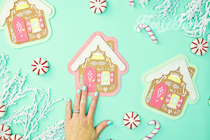 Final steps of assembling the felt gingerbread house ornament using fleecefun’s tutorial and free pattern