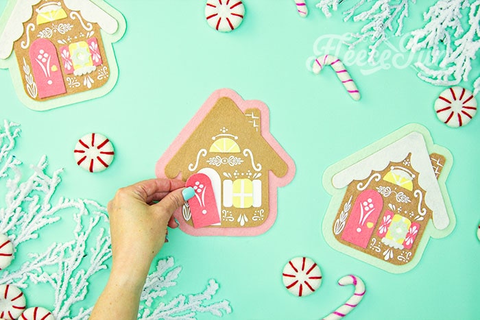 Bringing the felt gingerbread house ornament pieces together with fleecefun's free pattern