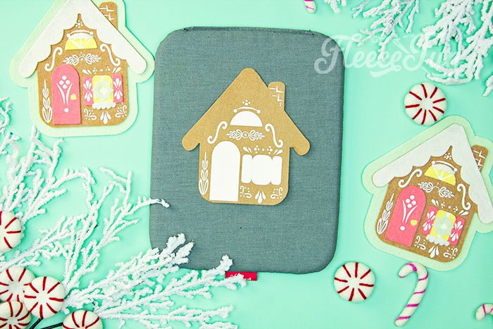 Heat transfer vinyl being applied to the felt gingerbread house ornament via fleecefun tutorial