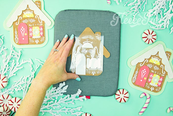 Adding HTV design to the gingerbread house ornament using fleecefun free template and tutorial