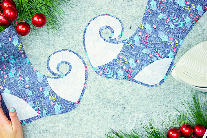 For the Elf Christmas stocking (Curly toed) iron on the interfacing to the toes and heels of the stocking body place it so it is approximately .25 of an inch from the edge.
