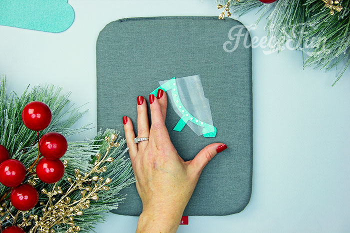 Applying HTV to the ice skate ornament using fleecefun's free tutorial