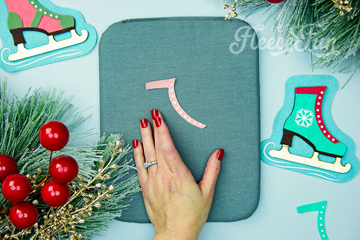 Applying HTV to the ice skate ornament using fleecefun's free tutorial