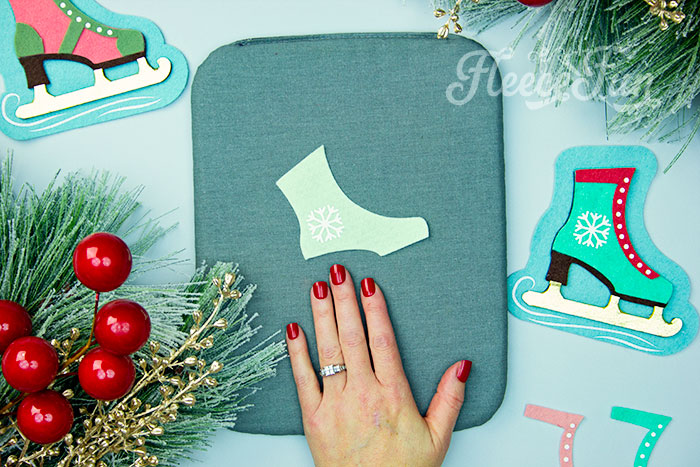 Applying HTV to the ice skate ornament using fleecefun's free tutorial