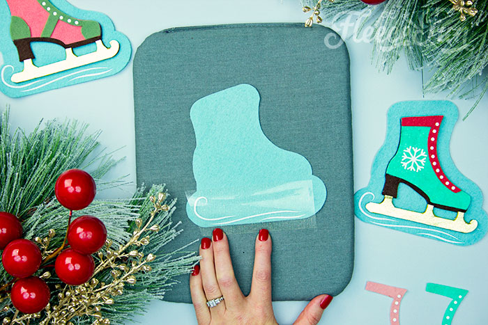 Applying HTV to the ice skate ornament using fleecefun's free tutorial