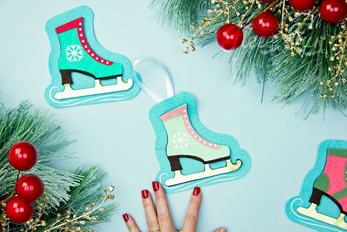 You can make this homemade Ice Skate ornament DIY (free pattern).  With a few materials, this no sew felt ornament can be a wonderful addition to your Christmas tree.  It also makes a lovely handmade gift for a loved one.  This free templates comes with two versions of the skate: one spats shoe style and one with a snowflake on the side.  You can also modify the pattern and eliminate the blue background if you wish.