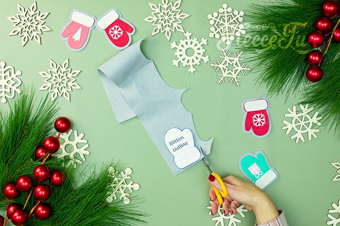 Tracing and cutting the free mitten ornament template from fleecefun.