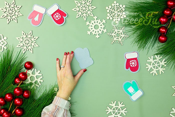 Cutting felt mitten ornament pieces using fleecefun's free pattern.