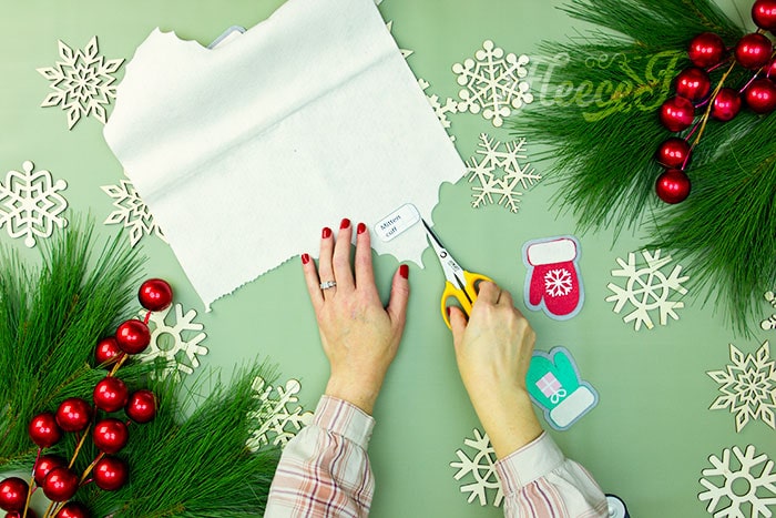 Tracing and cutting the free mitten ornament template from fleecefun.