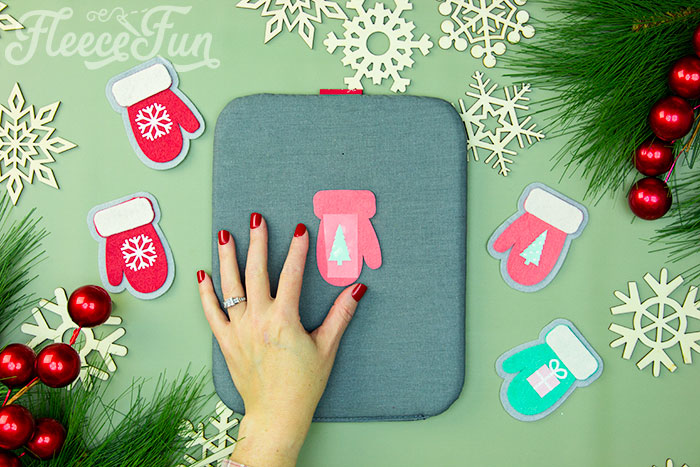 Applying HTV to a felt mitten ornament with fleecefun's tutorial.