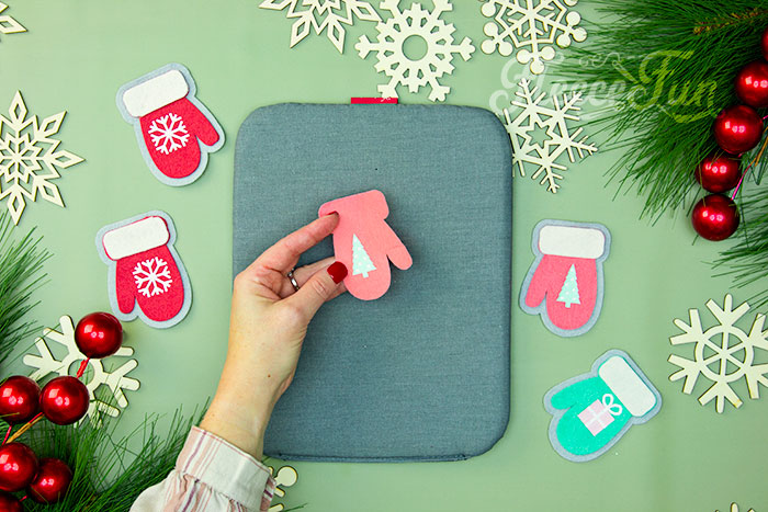Applying HTV to a felt mitten ornament with fleecefun's tutorial.