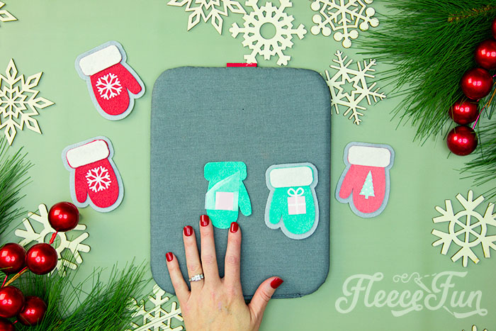 Applying HTV to a felt mitten ornament with fleecefun's tutorial.