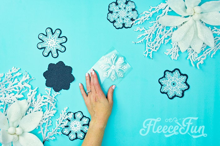 Step-by-step guide to applying HTV on fleecefun’s snowflake ornament