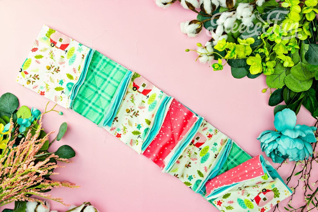 The rag quilt blocks sewn into a row. easy assembly makes this a good quilt for beginners.