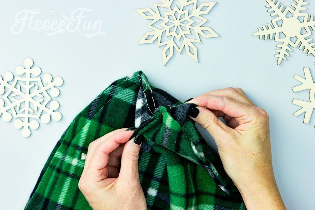 Take the bottom of each "v" on the top and bottom and pull so now the seams you just sewed are touching