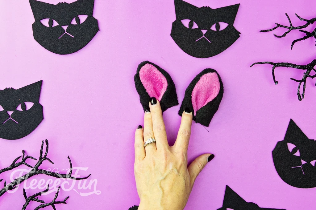 Cat Ear: Turn each bottom corner into center of ear, pin and baste stitch down.