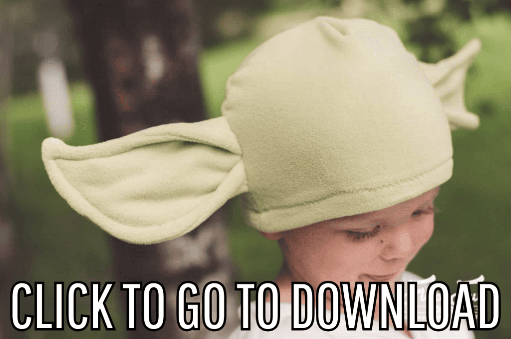 A green hat with ears, similar to baby yoda from the mandalorian, perfect for winter and halloween parties, made with free pattern and step by step tutorial from fleece fun, with the text "CLICK TO GO TO DOWNLOAD" displayed at the bottom.
