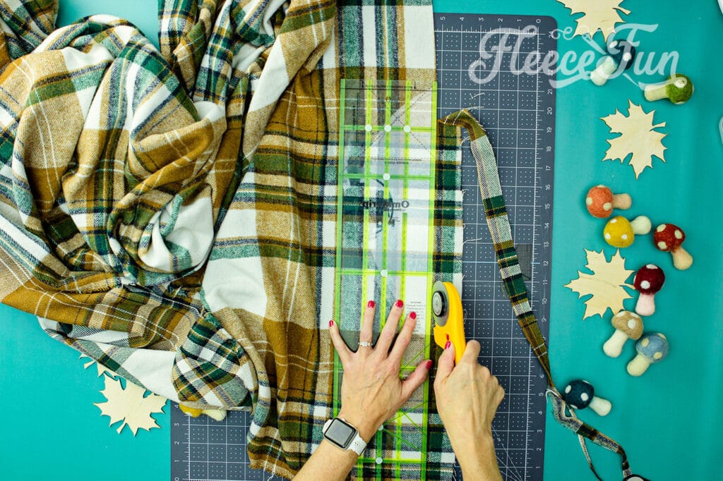Cutting and prepping raw edges of the flannel fabric for no sew blanket fringe.