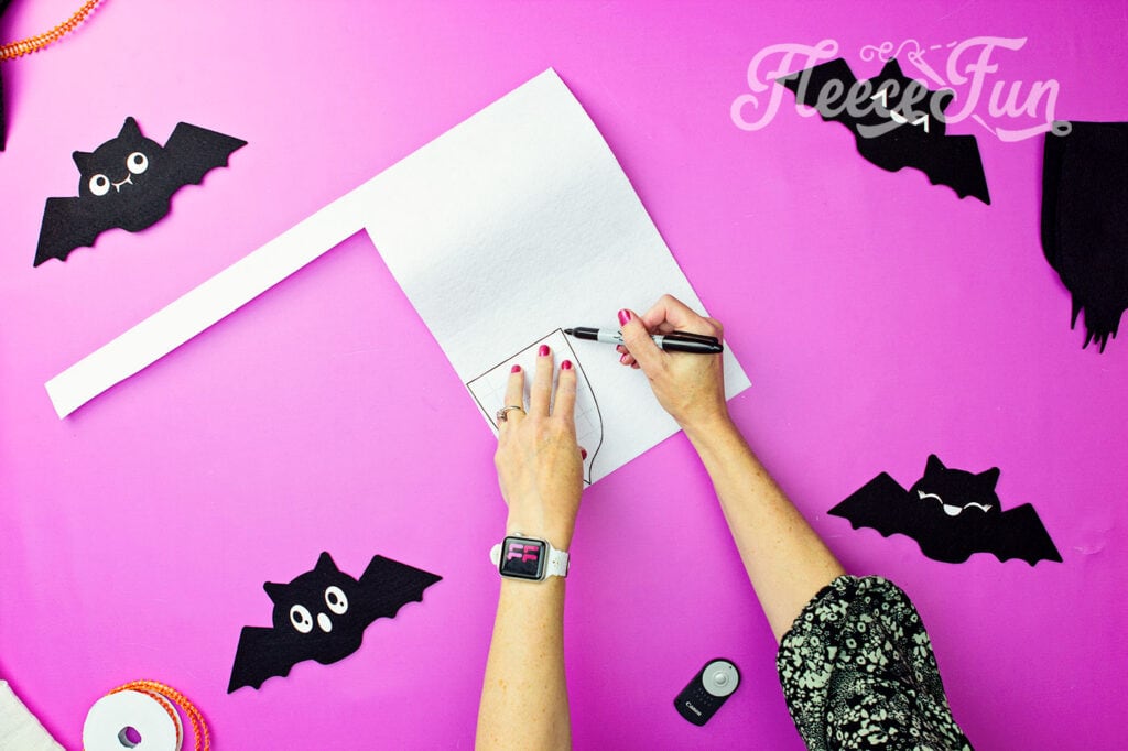 Start your DIY Halloween banner project by cutting out the free Trick or Treat template from fleecefun.
