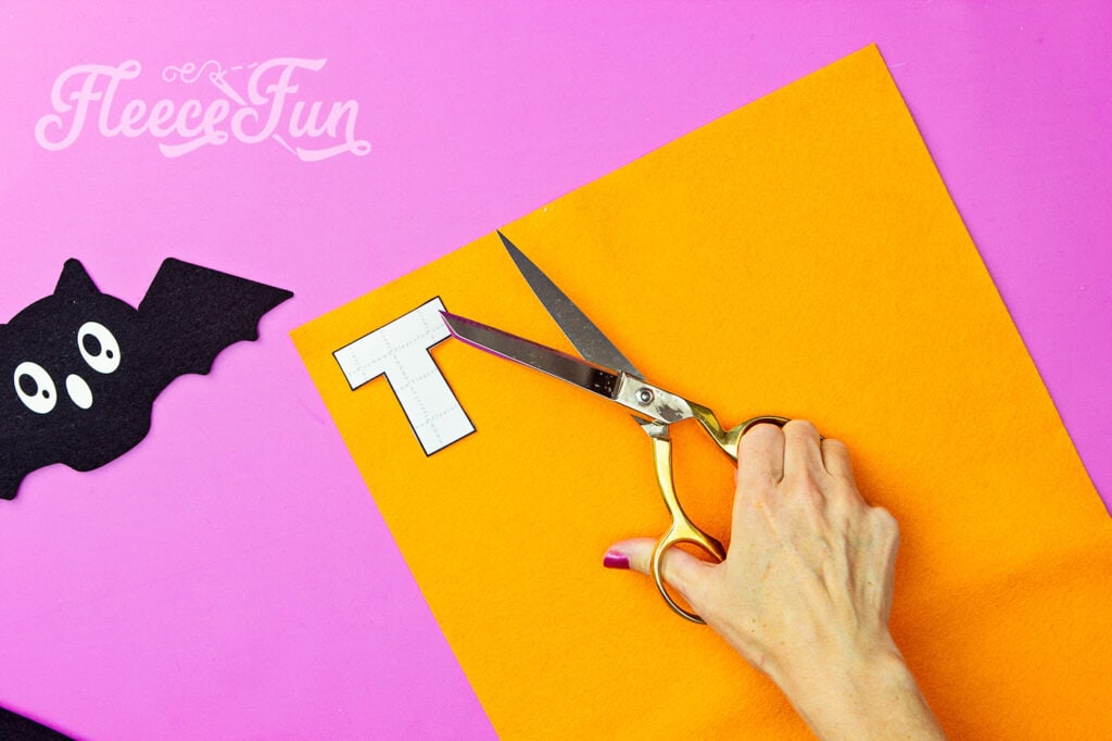 Cutting out the Trick or Treat banner pieces using the free template from fleecefun.