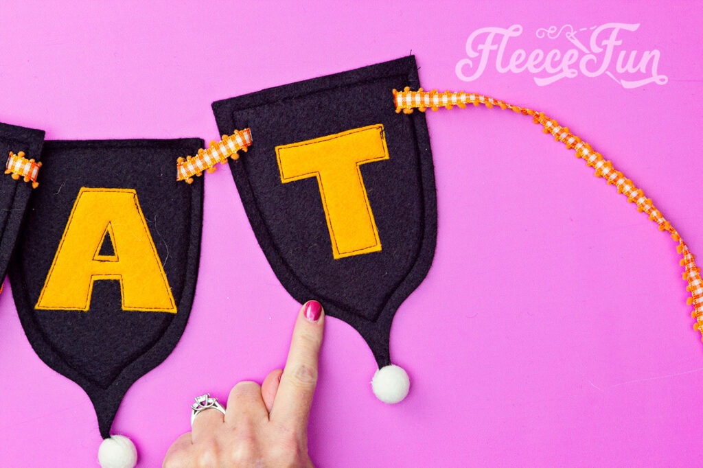 sew around the edges of the felt banner
