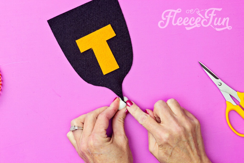 tucking the end of each flag into a pompom