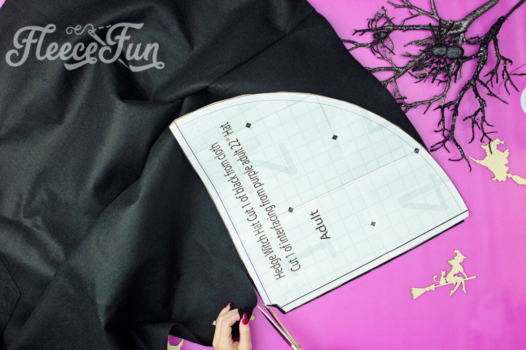 Preparing the Hedge Witch Hat pattern by cutting out the cone with fleece fun’s free tutorial.